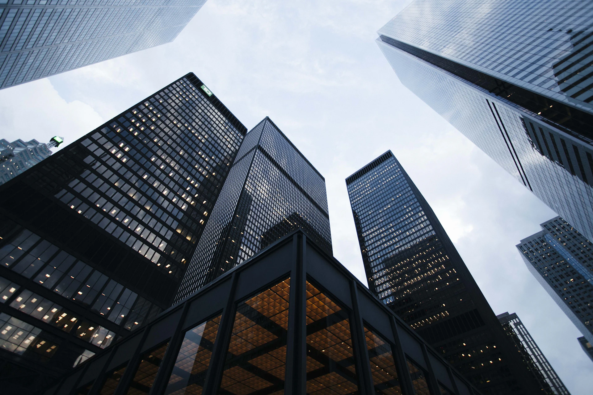 Modern glass architecture viewed from below; illustrative image